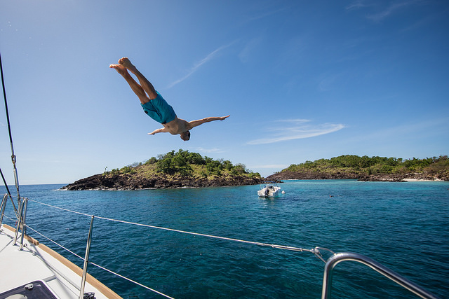 Young man diving from a yacht.